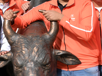 Managing Director and Group Chief Executive Officer of Swiggy, Sriharsha Majety, poses with the statue of the NSE bull ahead of the listing...