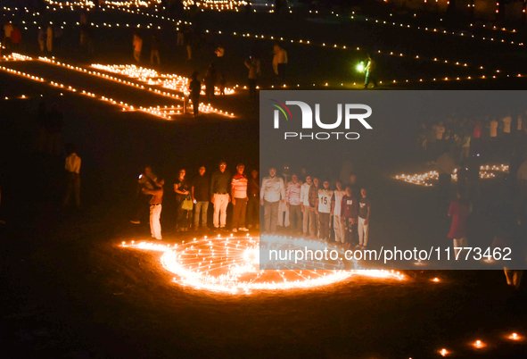 Athletes and members of a sports complex celebrate post-Diwali in a ground by lighting candles and firecrackers in Allahabad, India, on Nove...