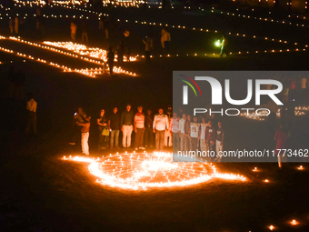 Athletes and members of a sports complex celebrate post-Diwali in a ground by lighting candles and firecrackers in Allahabad, India, on Nove...