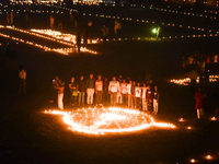 Athletes and members of a sports complex celebrate post-Diwali in a ground by lighting candles and firecrackers in Allahabad, India, on Nove...