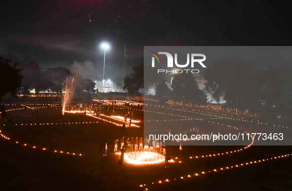 Athletes and members of a sports complex celebrate post-Diwali in a ground by lighting candles and firecrackers in Allahabad, India, on Nove...