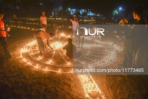 Athletes and members of a sports complex celebrate post-Diwali in a ground by lighting candles and firecrackers in Allahabad, India, on Nove...