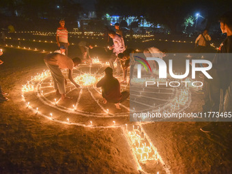 Athletes and members of a sports complex celebrate post-Diwali in a ground by lighting candles and firecrackers in Allahabad, India, on Nove...