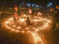 Athletes and members of a sports complex celebrate post-Diwali in a ground by lighting candles and firecrackers in Allahabad, India, on Nove...