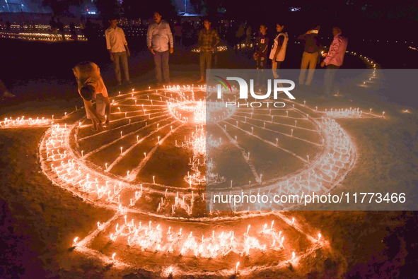 Athletes and members of a sports complex celebrate post-Diwali in a ground by lighting candles and firecrackers in Allahabad, India, on Nove...