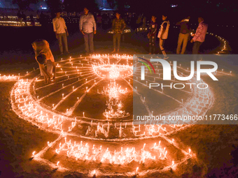 Athletes and members of a sports complex celebrate post-Diwali in a ground by lighting candles and firecrackers in Allahabad, India, on Nove...