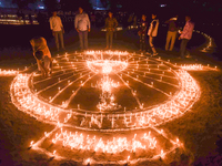 Athletes and members of a sports complex celebrate post-Diwali in a ground by lighting candles and firecrackers in Allahabad, India, on Nove...