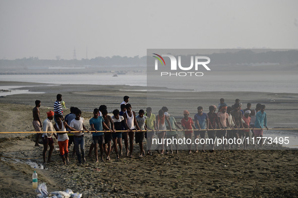 Labourers build a floating pontoon bridge across the river Ganges for devotees ahead of the upcoming Maha Kumbh 2025 festival in Prayagraj,...