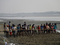 Labourers build a floating pontoon bridge across the river Ganges for devotees ahead of the upcoming Maha Kumbh 2025 festival in Prayagraj,...