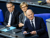 German Chancellor Olaf Scholz (R) prepares to hold a Government Declaration at the lower house of Parliament Bundestag in Berlin, Germany, o...