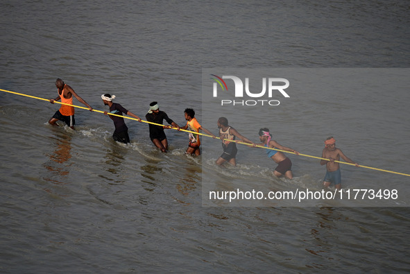 Labourers build a floating pontoon bridge across the river Ganges for devotees ahead of the upcoming Maha Kumbh 2025 festival in Prayagraj,...