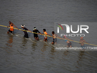 Labourers build a floating pontoon bridge across the river Ganges for devotees ahead of the upcoming Maha Kumbh 2025 festival in Prayagraj,...