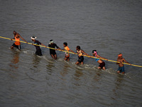 Labourers build a floating pontoon bridge across the river Ganges for devotees ahead of the upcoming Maha Kumbh 2025 festival in Prayagraj,...