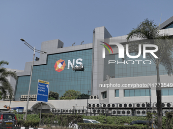 Workers hang outside the National Stock Exchange (NSE) building in the business district of Mumbai, India, on November 13, 2024. (