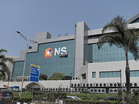 Workers hang outside the National Stock Exchange (NSE) building in the business district of Mumbai, India, on November 13, 2024. (