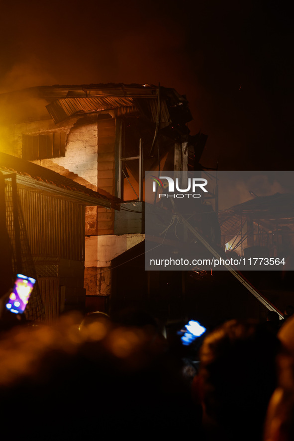 Firefighters try to douse the flames after a fire breaks out in the industrial area of Sopore, Jammu and Kashmir, India, on November 13, 202...