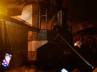 Firefighters try to douse the flames after a fire breaks out in the industrial area of Sopore, Jammu and Kashmir, India, on November 13, 202...