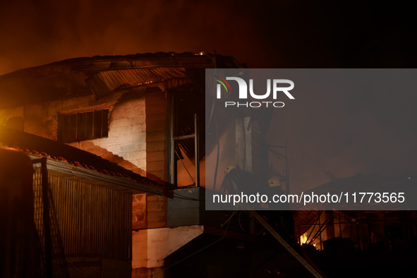 Firefighters try to douse the flames after a fire breaks out in the industrial area of Sopore, Jammu and Kashmir, India, on November 13, 202...