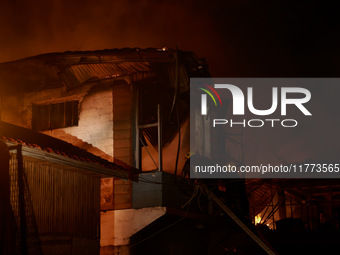 Firefighters try to douse the flames after a fire breaks out in the industrial area of Sopore, Jammu and Kashmir, India, on November 13, 202...