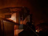 Firefighters try to douse the flames after a fire breaks out in the industrial area of Sopore, Jammu and Kashmir, India, on November 13, 202...