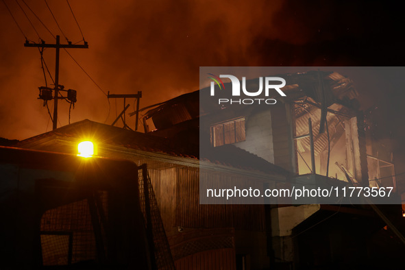 Firefighters try to douse the flames after a fire breaks out in the industrial area of Sopore, Jammu and Kashmir, India, on November 13, 202...