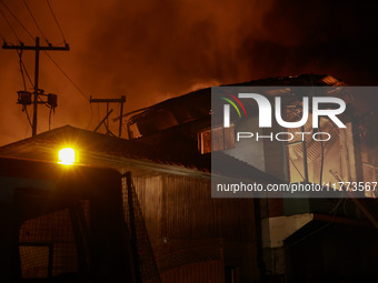 Firefighters try to douse the flames after a fire breaks out in the industrial area of Sopore, Jammu and Kashmir, India, on November 13, 202...