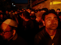 People watch as firefighters try to douse the flames after a fire breaks out in the industrial area of Sopore, Jammu and Kashmir, India, on...