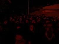 People watch as firefighters try to douse the flames after a fire breaks out in the industrial area of Sopore, Jammu and Kashmir, India, on...