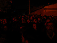 People watch as firefighters try to douse the flames after a fire breaks out in the industrial area of Sopore, Jammu and Kashmir, India, on...