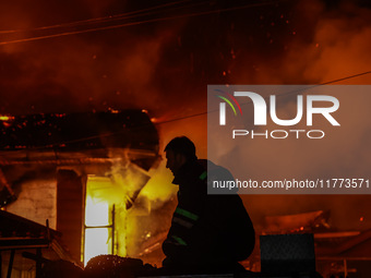 Firefighters try to douse the flames after a fire breaks out in the industrial area of Sopore, Jammu and Kashmir, India, on November 13, 202...