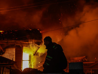 Firefighters try to douse the flames after a fire breaks out in the industrial area of Sopore, Jammu and Kashmir, India, on November 13, 202...