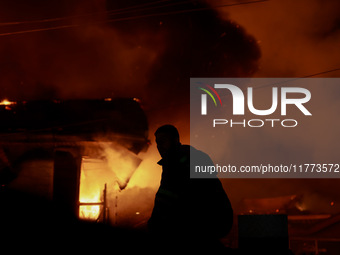 Firefighters try to douse the flames after a fire breaks out in the industrial area of Sopore, Jammu and Kashmir, India, on November 13, 202...