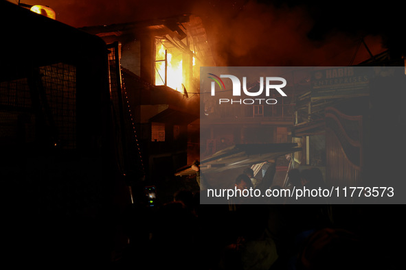 Firefighters try to douse the flames after a fire breaks out in the industrial area of Sopore, Jammu and Kashmir, India, on November 13, 202...