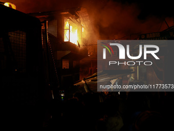 Firefighters try to douse the flames after a fire breaks out in the industrial area of Sopore, Jammu and Kashmir, India, on November 13, 202...