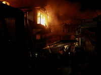 Firefighters try to douse the flames after a fire breaks out in the industrial area of Sopore, Jammu and Kashmir, India, on November 13, 202...