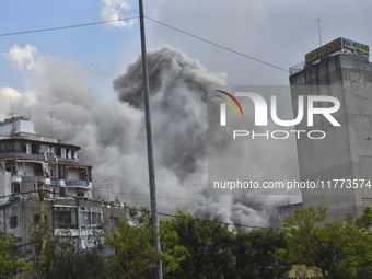 Smoke rises among the residential buildings following an Israeli attack on Ghobeiry municipality located in the Dahieh region in Beirut, Leb...