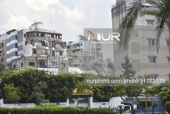 Smoke rises among the residential buildings following an Israeli attack on Ghobeiry municipality located in the Dahieh region in Beirut, Leb...