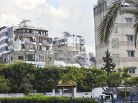 Smoke rises among the residential buildings following an Israeli attack on Ghobeiry municipality located in the Dahieh region in Beirut, Leb...