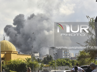 Smoke rises among the residential buildings following an Israeli attack on Ghobeiry municipality located in the Dahieh region in Beirut, Leb...