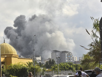 Smoke rises among the residential buildings following an Israeli attack on Ghobeiry municipality located in the Dahieh region in Beirut, Leb...