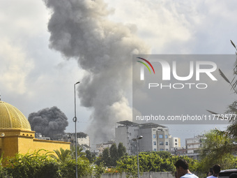 Smoke rises among the residential buildings following an Israeli attack on Ghobeiry municipality located in the Dahieh region in Beirut, Leb...