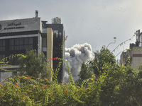 Smoke rises among the residential buildings following an Israeli attack on Ghobeiry municipality located in the Dahieh region in Beirut, Leb...