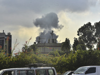 Smoke rises among the residential buildings following an Israeli attack on Ghobeiry municipality located in the Dahieh region in Beirut, Leb...