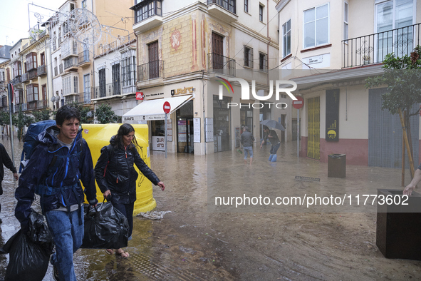 Heavy rainfall leads to significant flooding in various parts of Malaga, including major streets and public areas. 