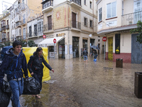 Heavy rainfall leads to significant flooding in various parts of Malaga, including major streets and public areas. (