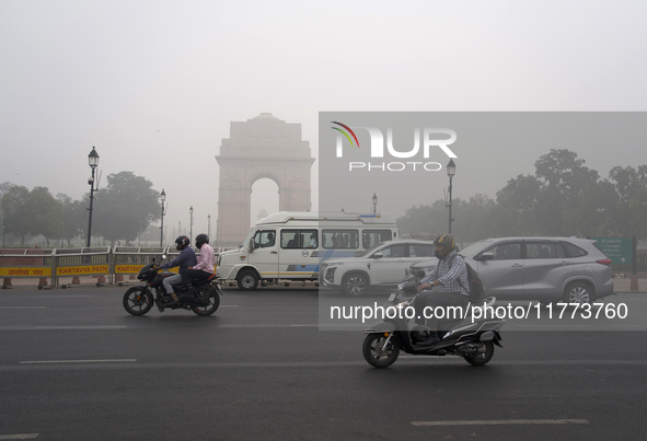 Traffic passes by India Gate, which is covered in a thick layer of smog, in New Delhi, India, on November 13, 2024 