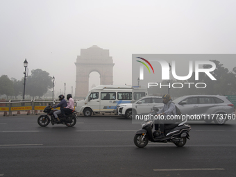 Traffic passes by India Gate, which is covered in a thick layer of smog, in New Delhi, India, on November 13, 2024 (