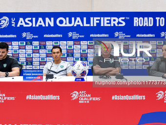 Uzbekistan national team assistant coach Vlado Radmanovich (2nd R) and player Otabek Shukurov (2nd L) attend a press conference at Jassim Bi...