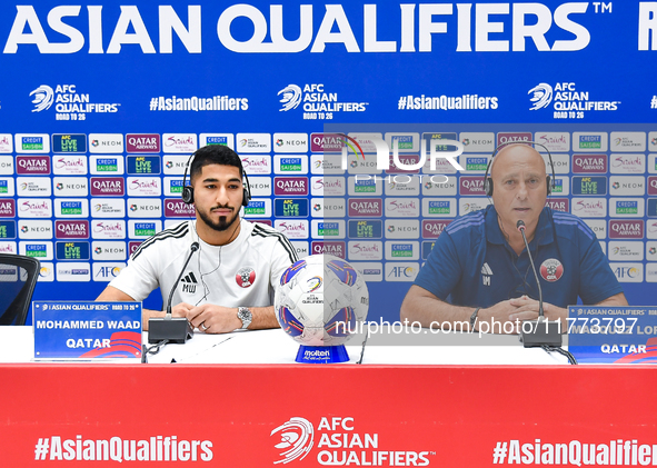 Qatar national team head coach Marquez Lopez (R) and player Mohammed Waad (L) attend a press conference at Jassim Bin Hamad Stadium in Doha,...