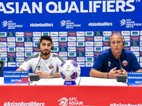 Qatar national team head coach Marquez Lopez (R) and player Mohammed Waad (L) attend a press conference at Jassim Bin Hamad Stadium in Doha,...